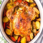 dutch oven whole roast chicken on a bed of vegetables