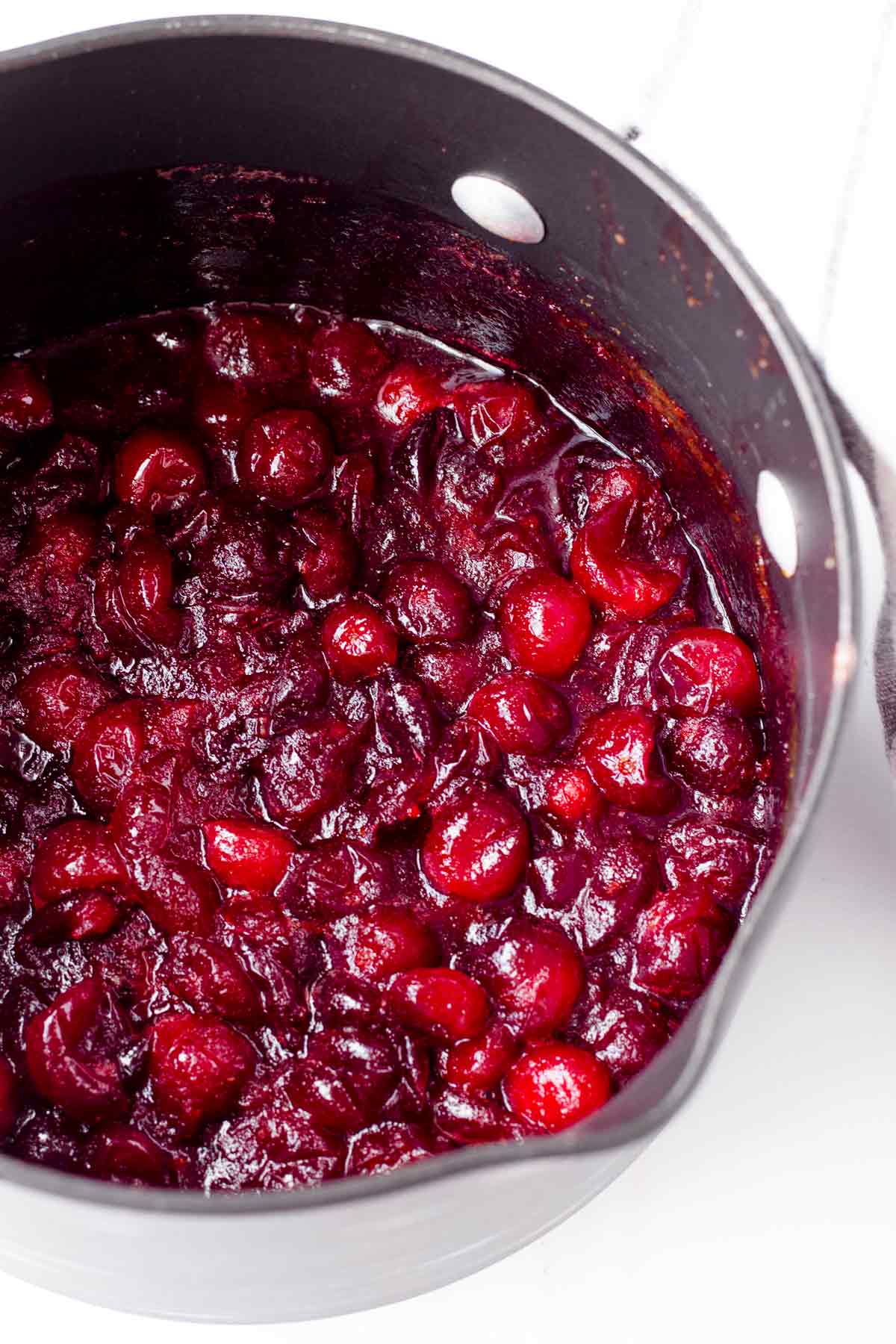 a saucepan with reduced cranberries