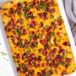 mashed potatoes topped with cheese, bacon, scallions