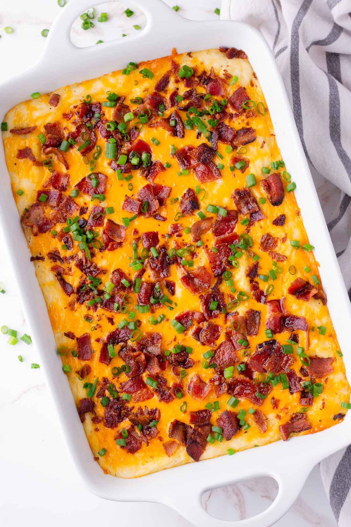 mashed potatoes topped with cheese, bacon, scallions