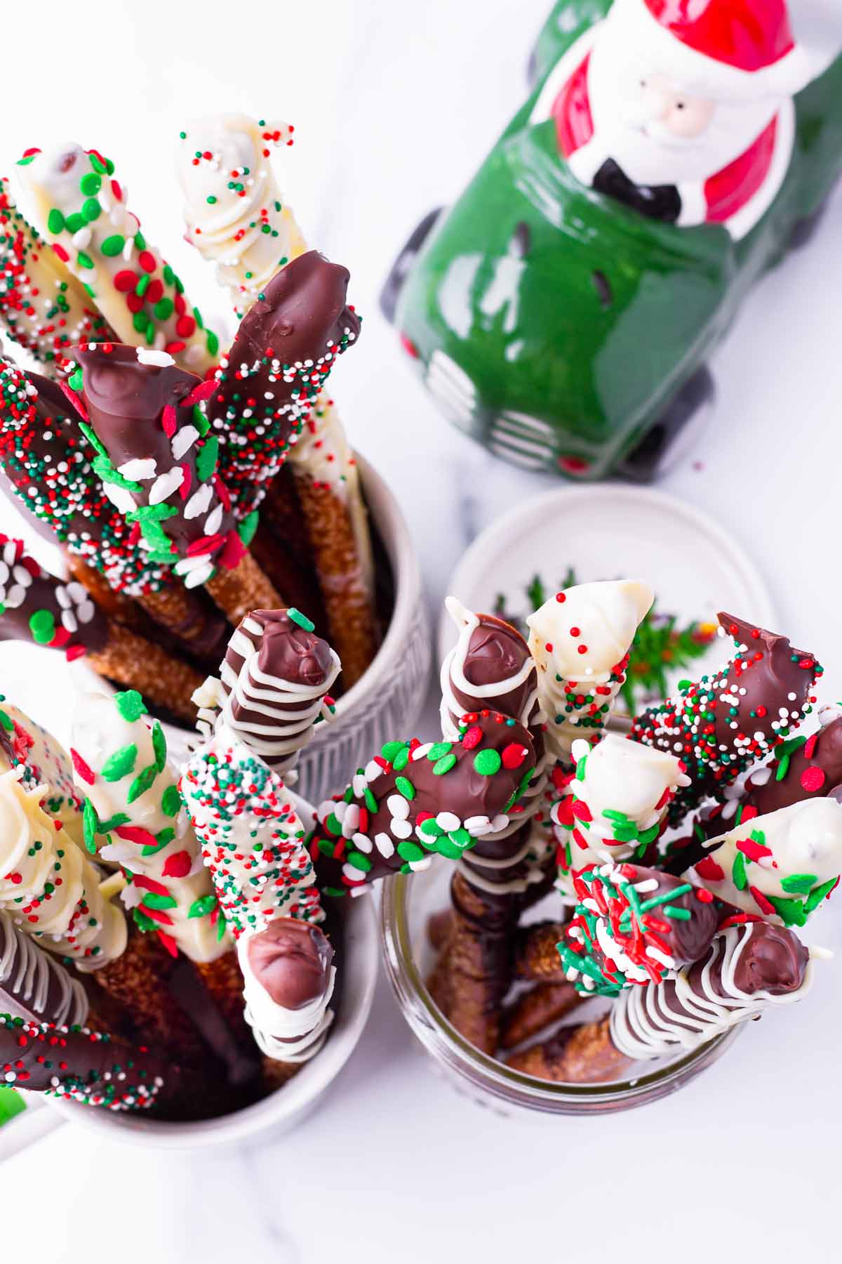 top view of chocolate pretzel rods with holiday sprinkles