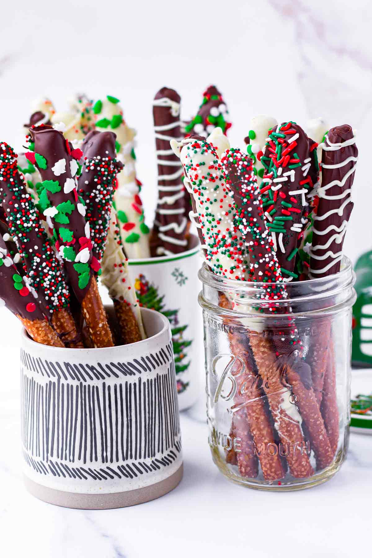 assorted chocolate covered pretzel rods with Christmas decorations
