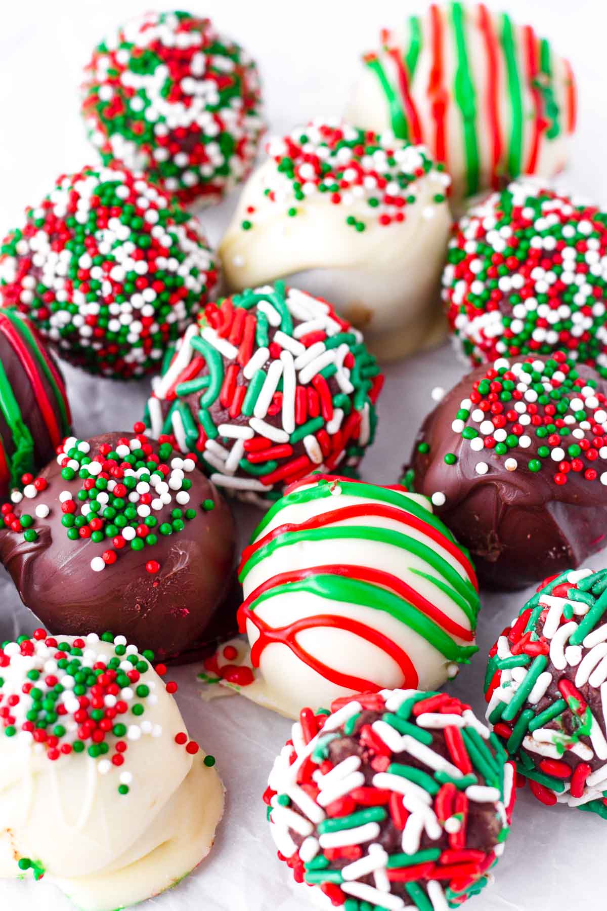 close up of red, green, and white chocolate truffles