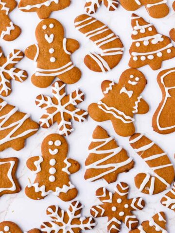 gingerbread cookies with icing laid out on table