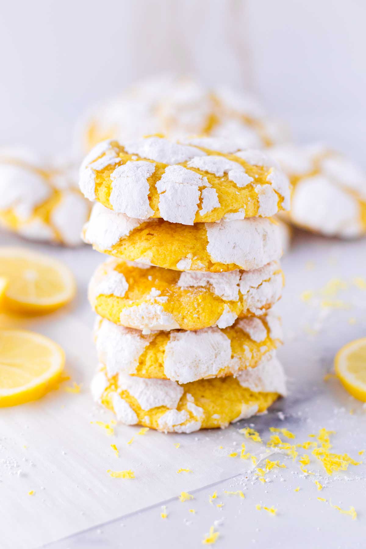 five lemon crinkle cookies stacked on top of each other