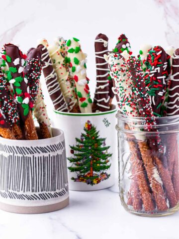 assorted holiday chocolate covered pretzel rods in mugs