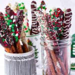 assorted holiday themed chocolate dipped pretzel in mugs