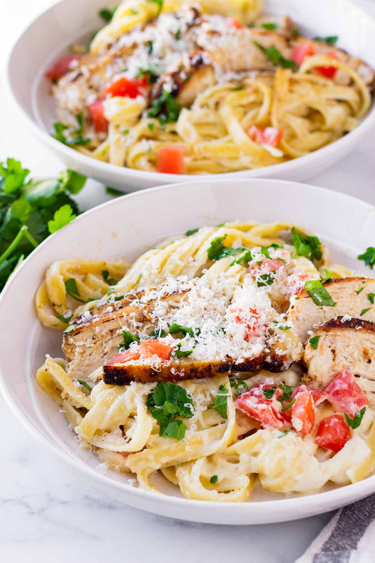 two alfredo pasta bowls with blackened chicken