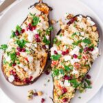 two stuffed eggplant boats with mediterranean filling