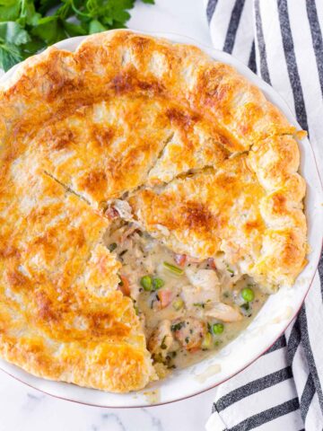 a whole chicken pot pie with a slice cut out