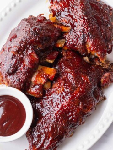caramelized baby back ribs served with BBQ sauce