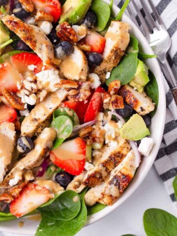 assembled strawberry and spinach salad with chicken