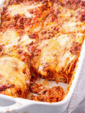 baked lasagna bolognese in a white baking dish