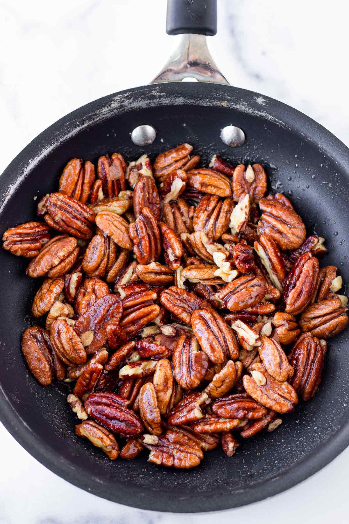 candied pecans in a small skillet