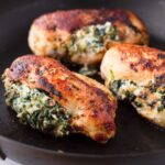 spinach stuffed chicken breast with ricotta on skillet