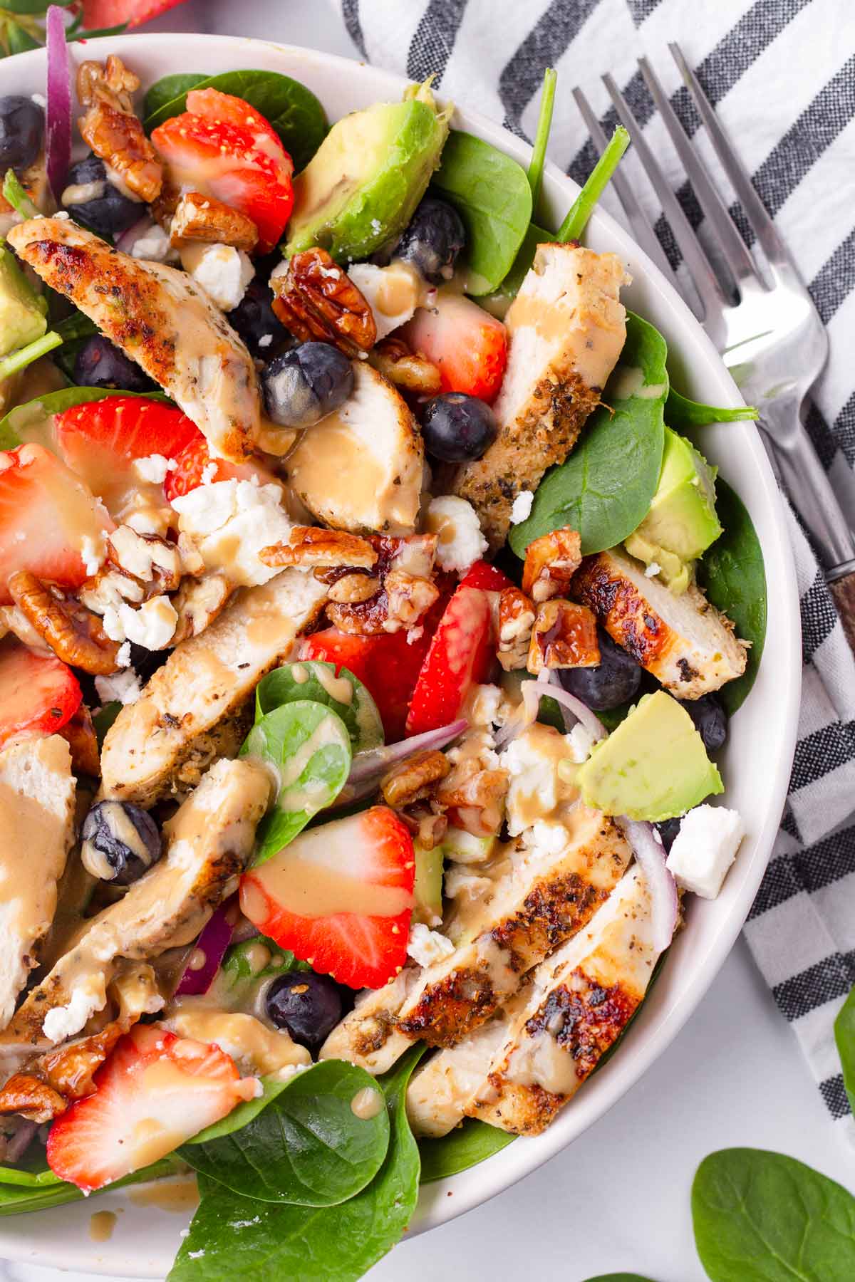 assembled strawberry and spinach salad with chicken