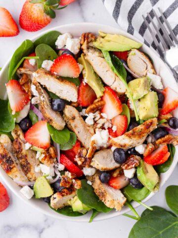 strawberry chicken salad with spinach in bowl