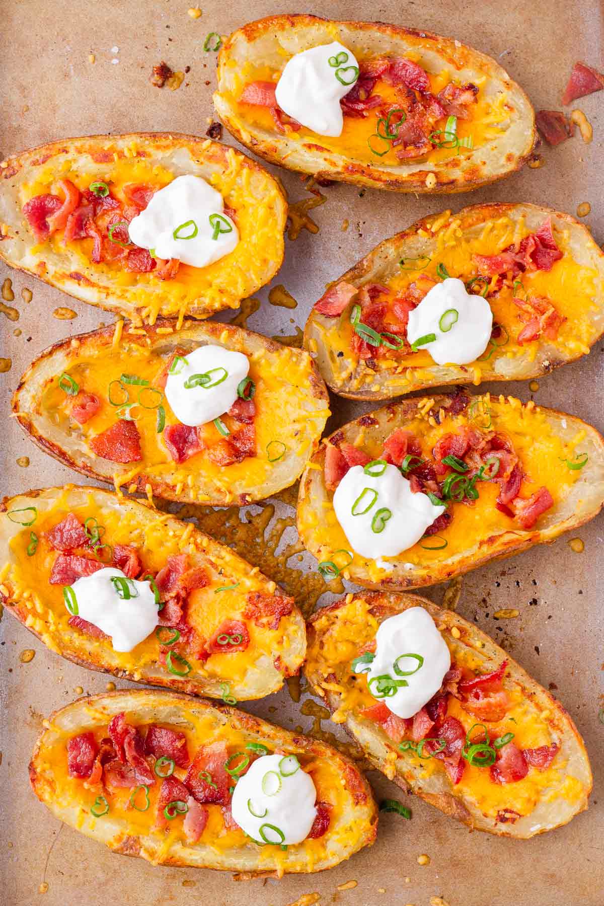 top view of eight loaded potato skins with cheese and bacon