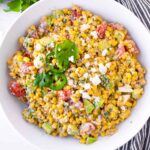 a round bowl with mexican street corn salad