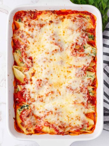 baked cheesy and golden brown tray of stuffed pasta shells