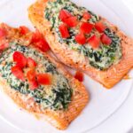two salmon fillets with spinach and ricotta stuffing and tomatoes