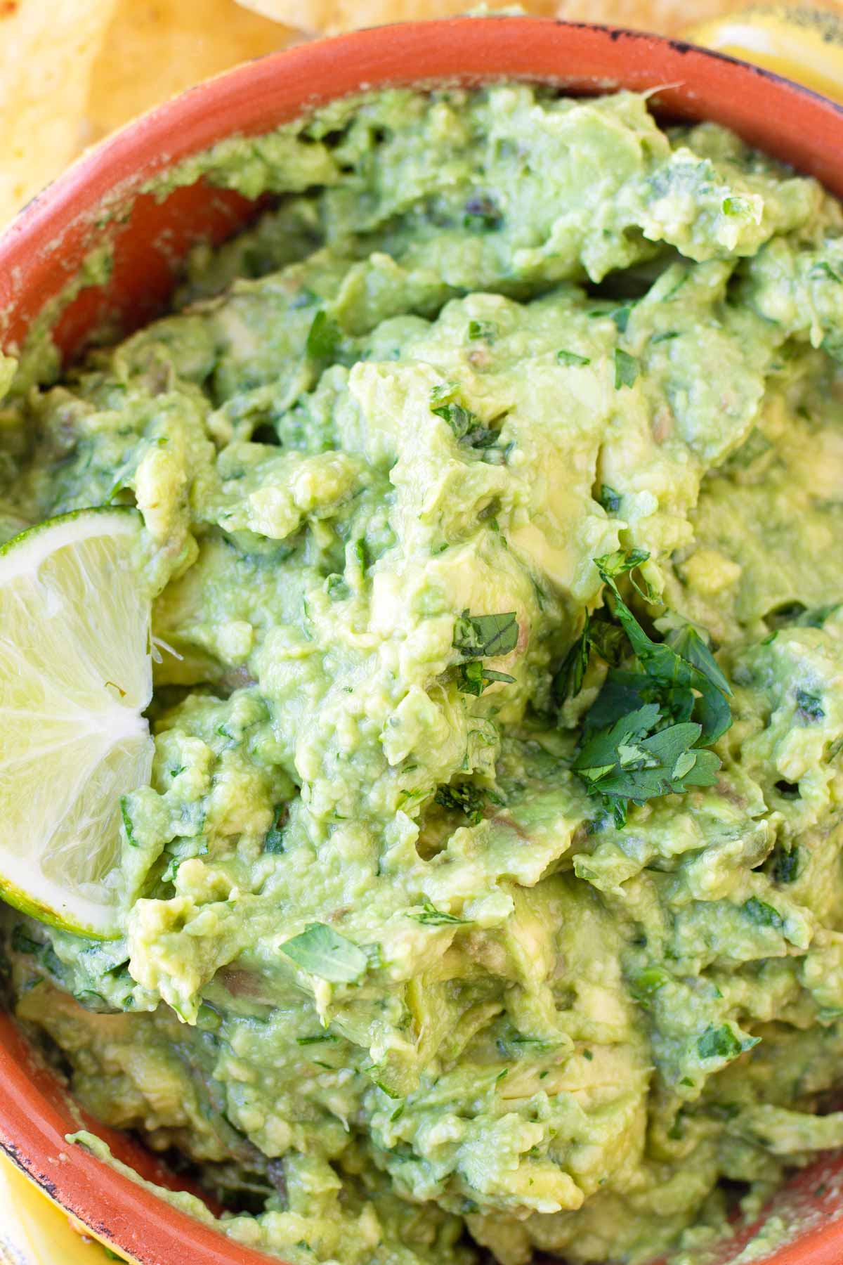 close up of guacamole dip with a slice of lime