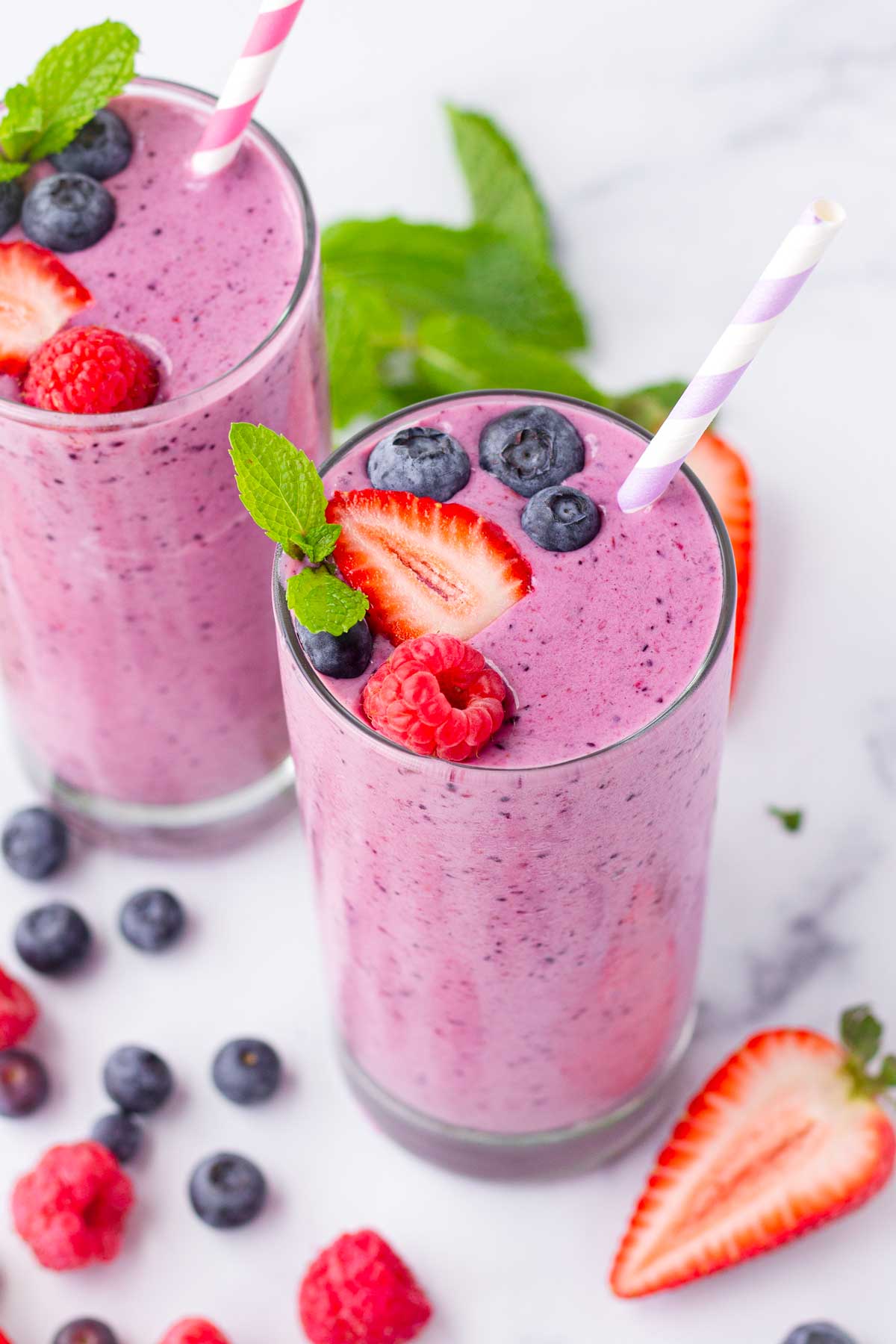 tropical fresh triple berry smoothies with paper straws