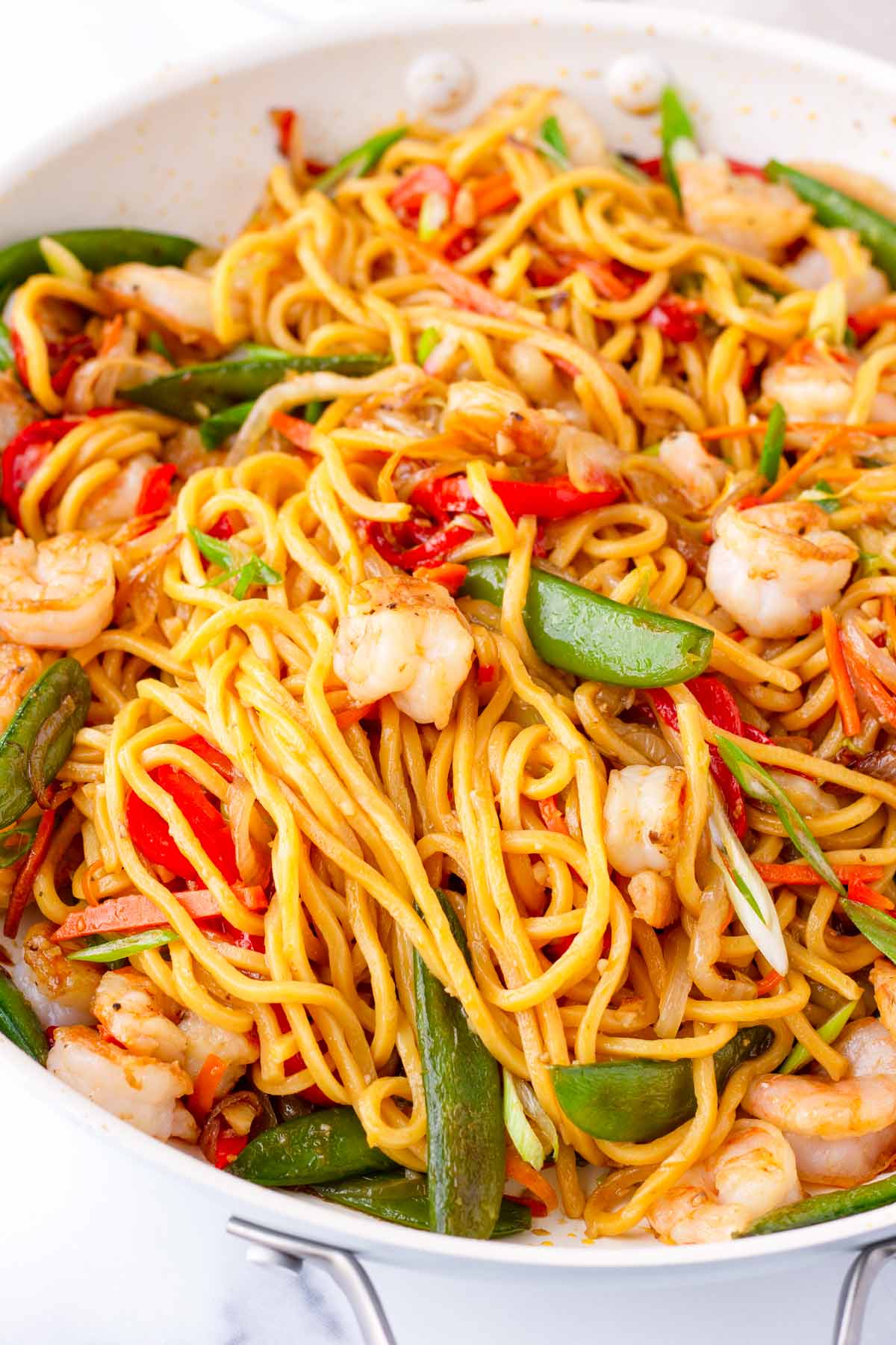 close up of shrimp lo mein with vegetables on skillet