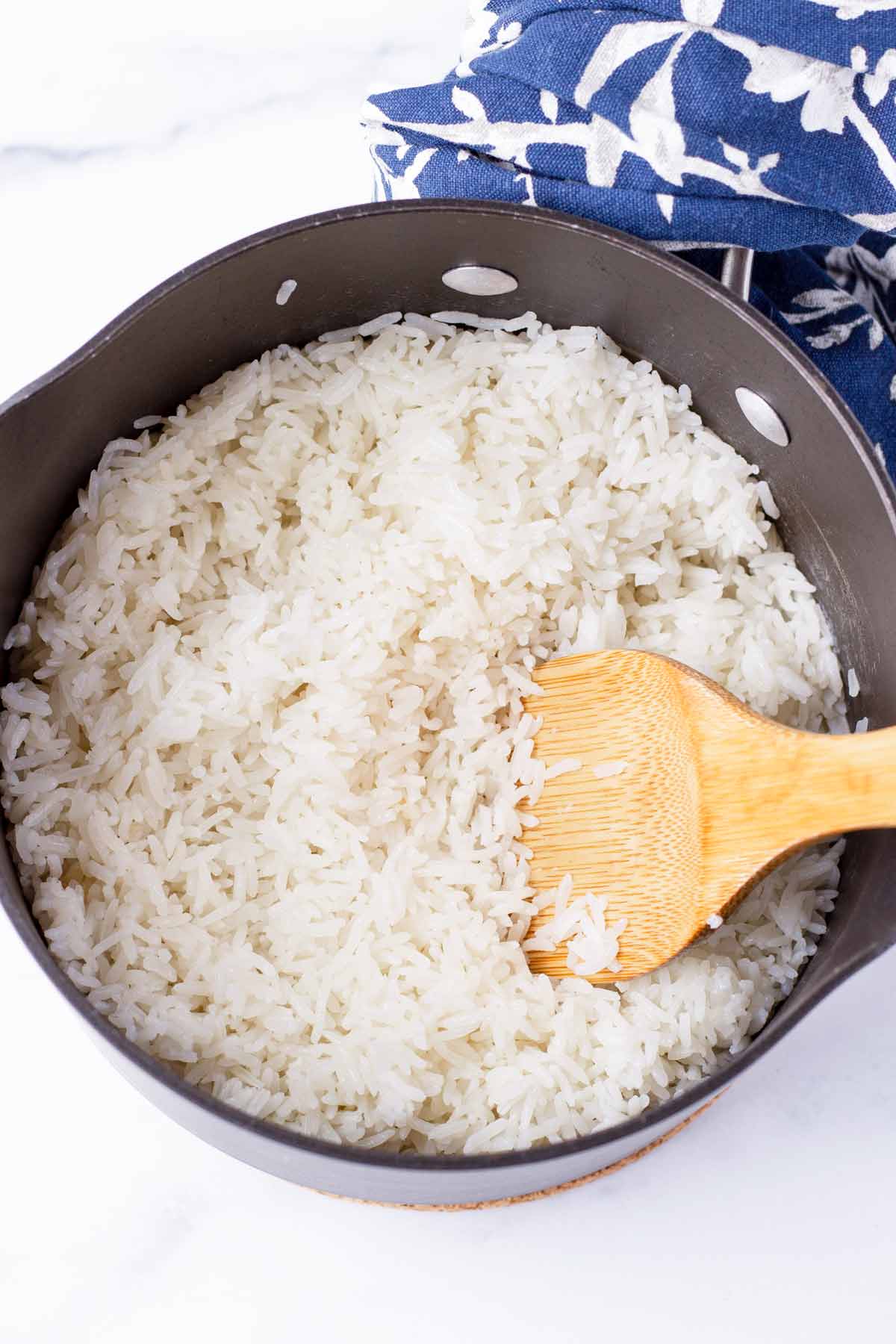 stirring rice in a pot with a spatula