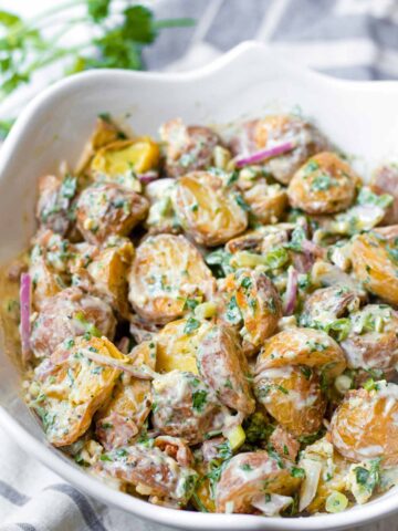garnished creamy blue cheese potato salad in serving bowl