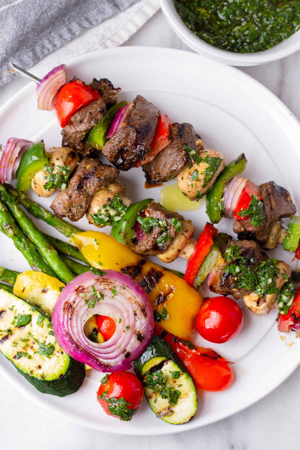 grilled steeak kabobs and vegetables brushed with chimichurri