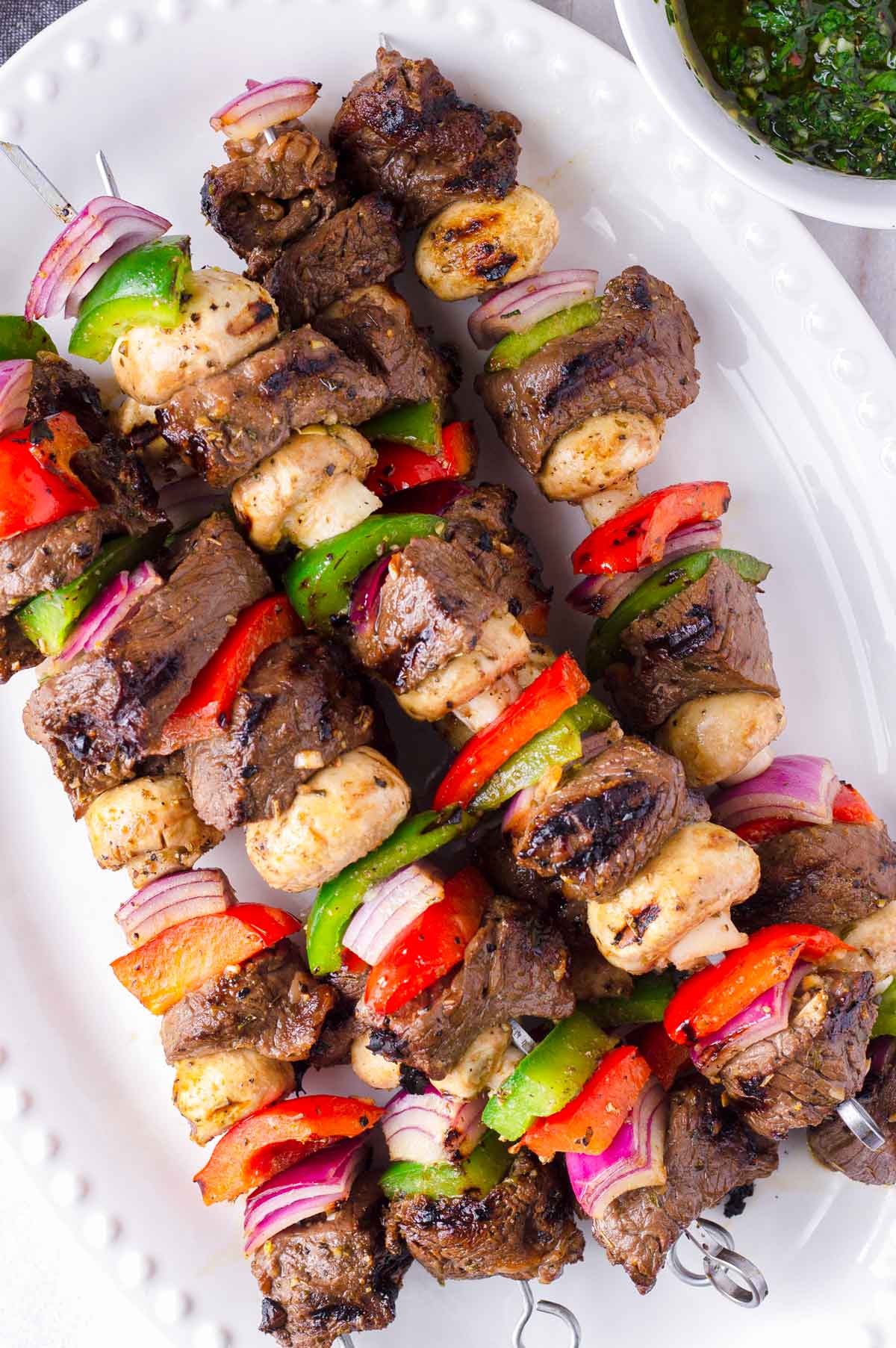 top view of assembled and grille beef kabobs with veggies