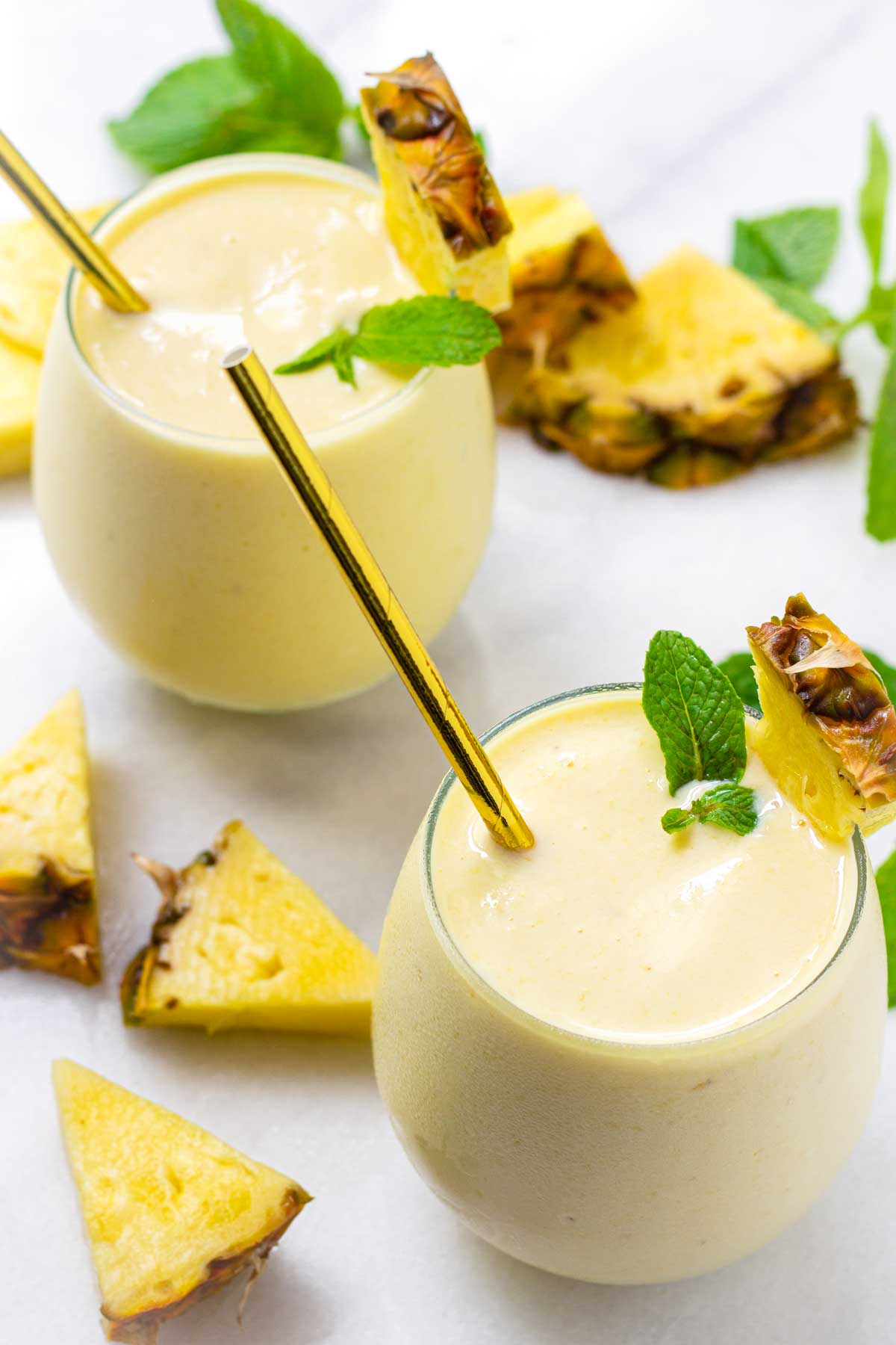 two glasses of tropical pineapple smoothies
