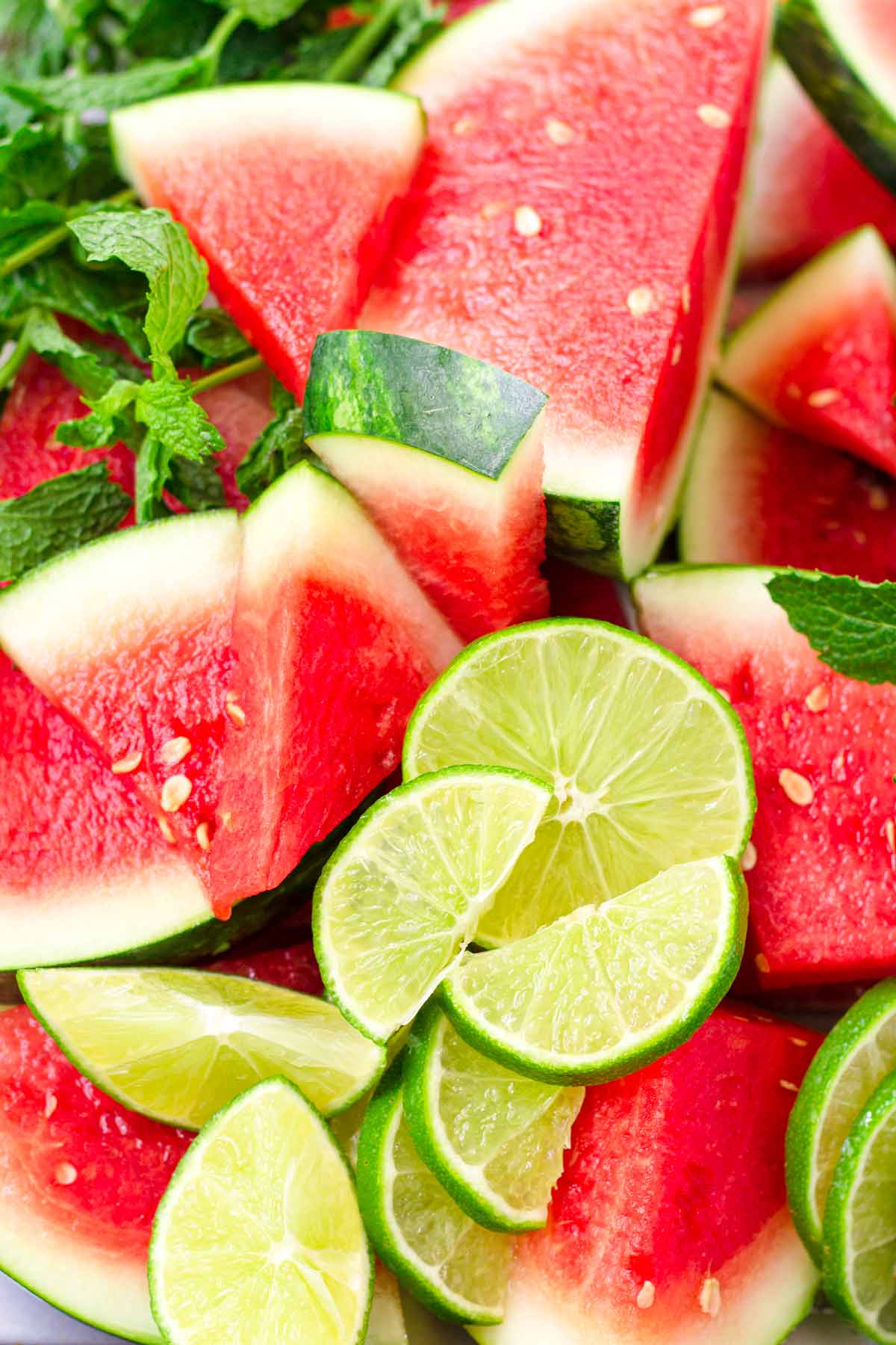 sliced watermelon, limes, and mint