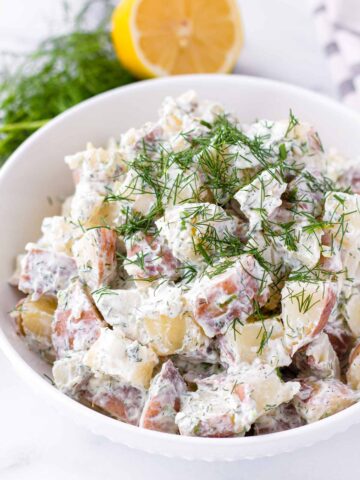 dill potato salad with fresh dill garnish on top