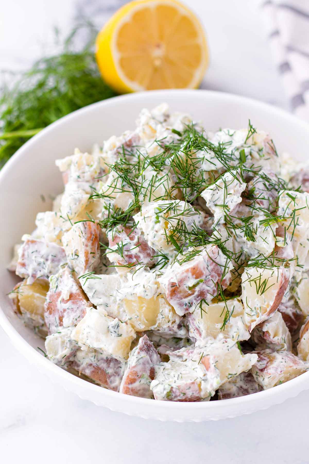 dill potato salad with fresh dill garnish on top