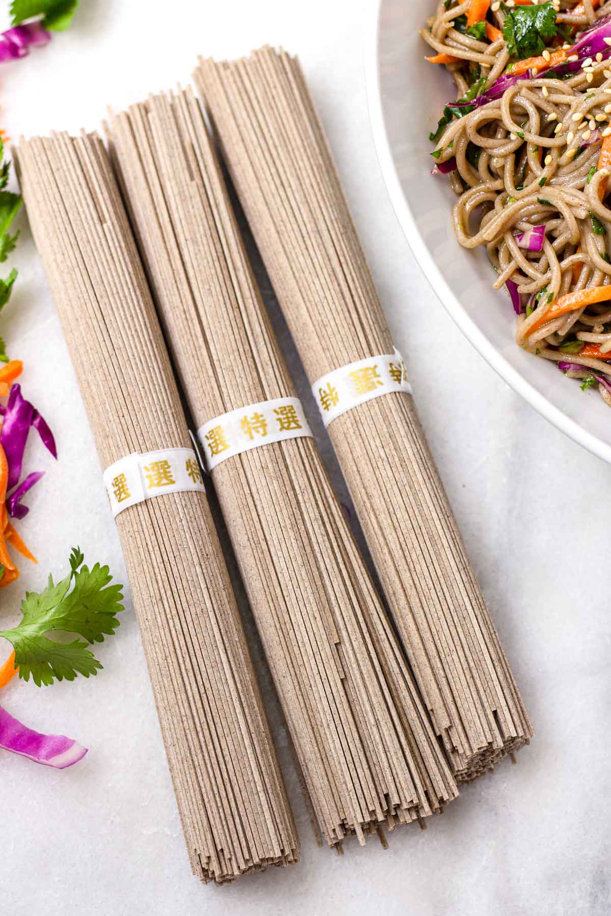 three bundles of uncooked dried soba buckwheat noodles