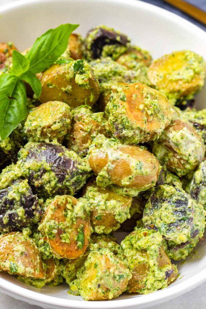 the final dish of creamy pesto potato salad garnished