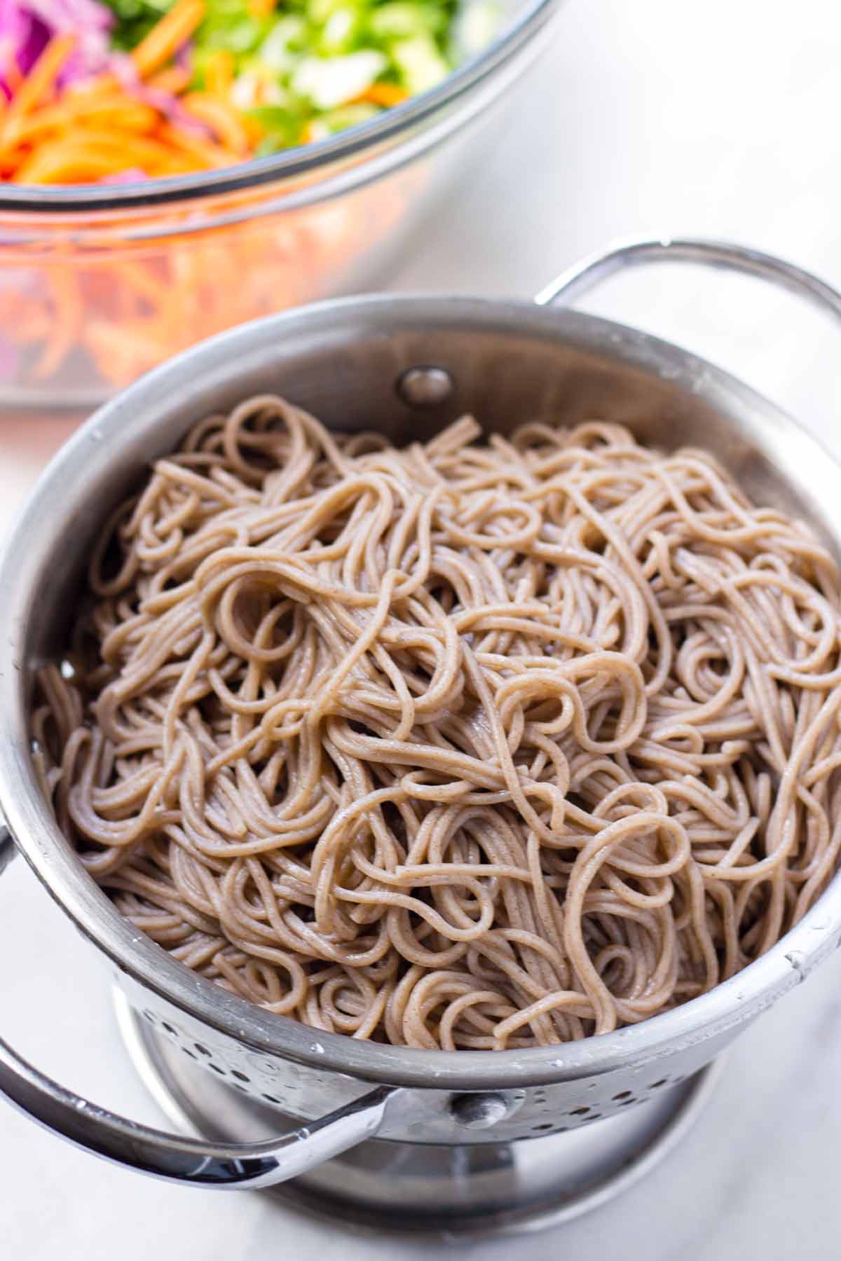 cooked and drained soba noodles in a colander