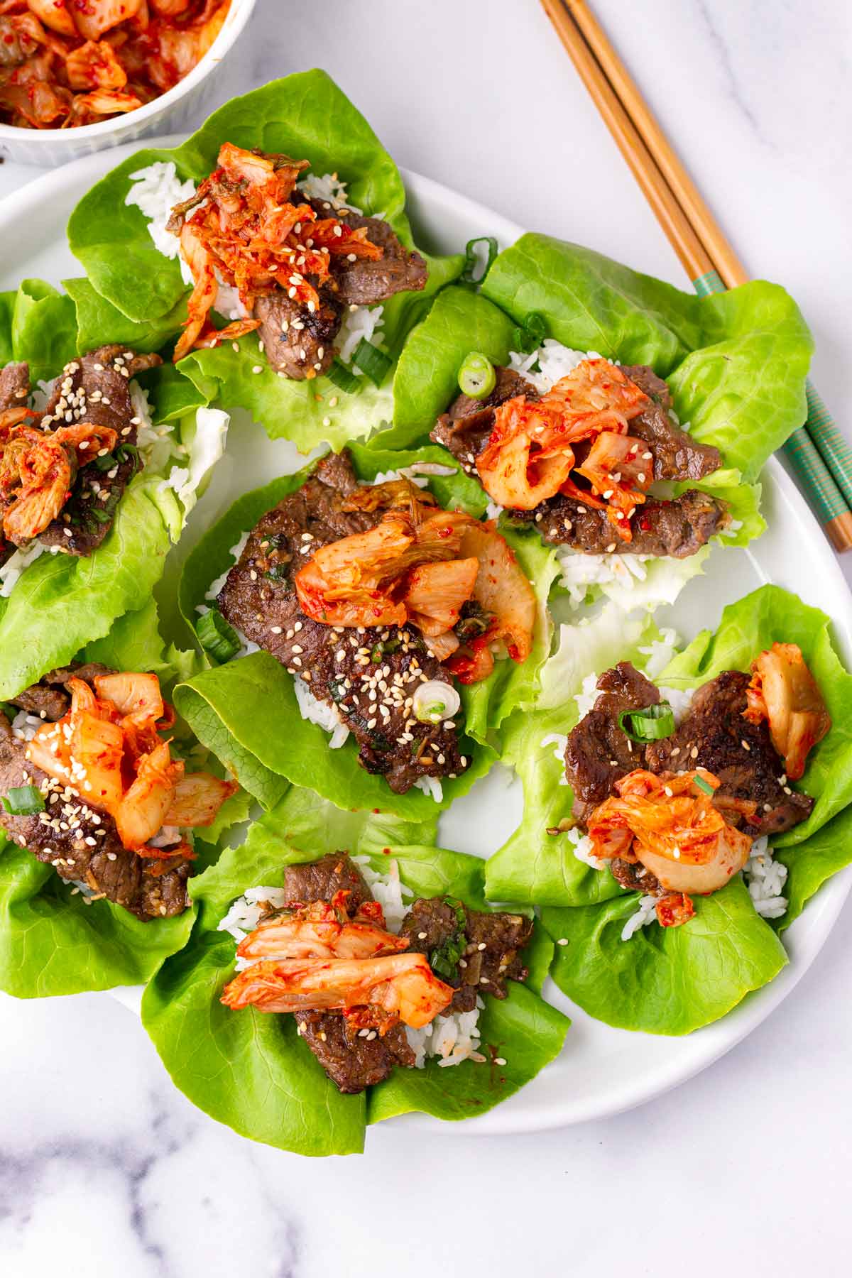 bulgogi lettuce wraps with rice and topped with kimchi