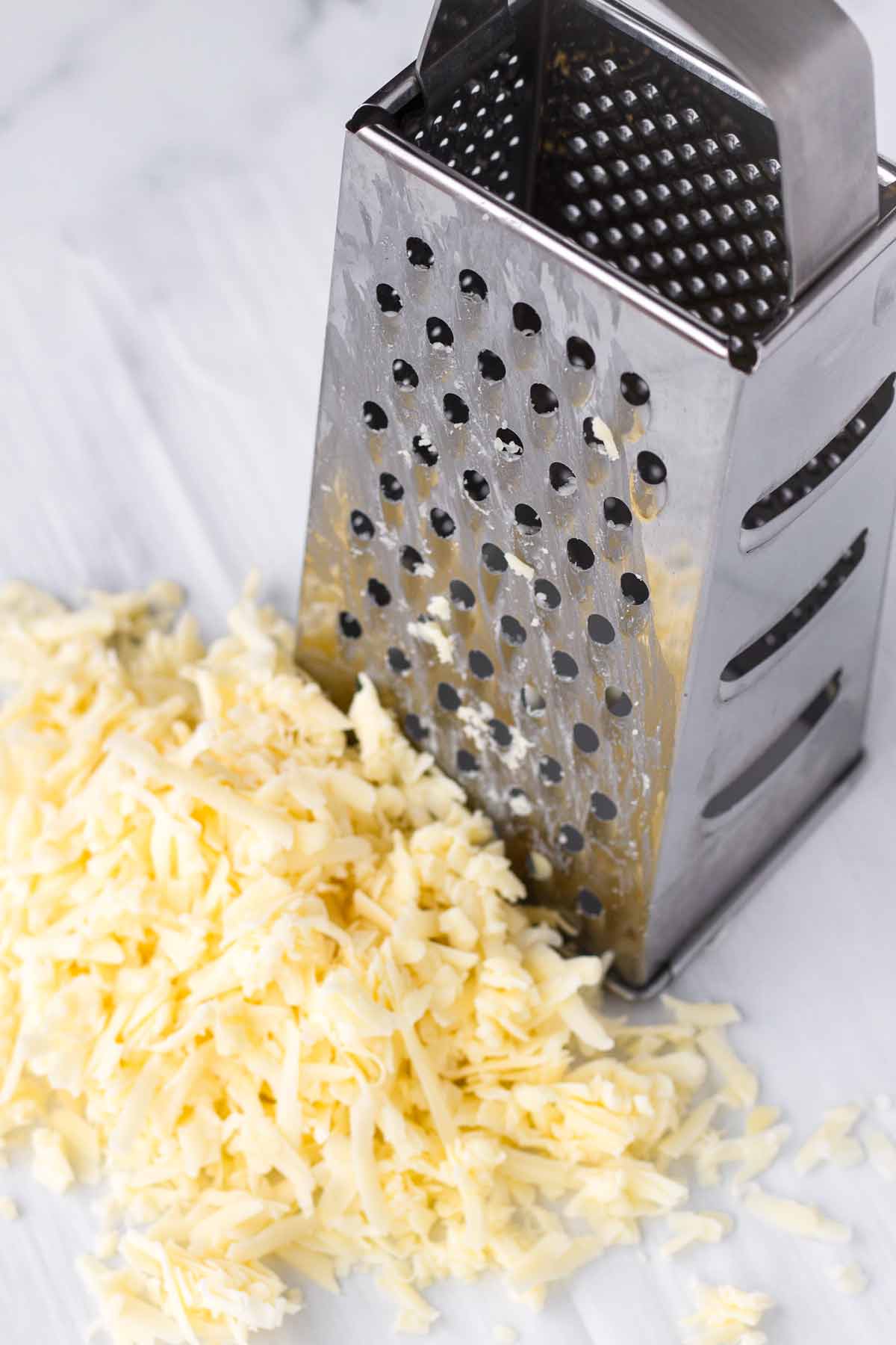 grated cheese next to a box grater