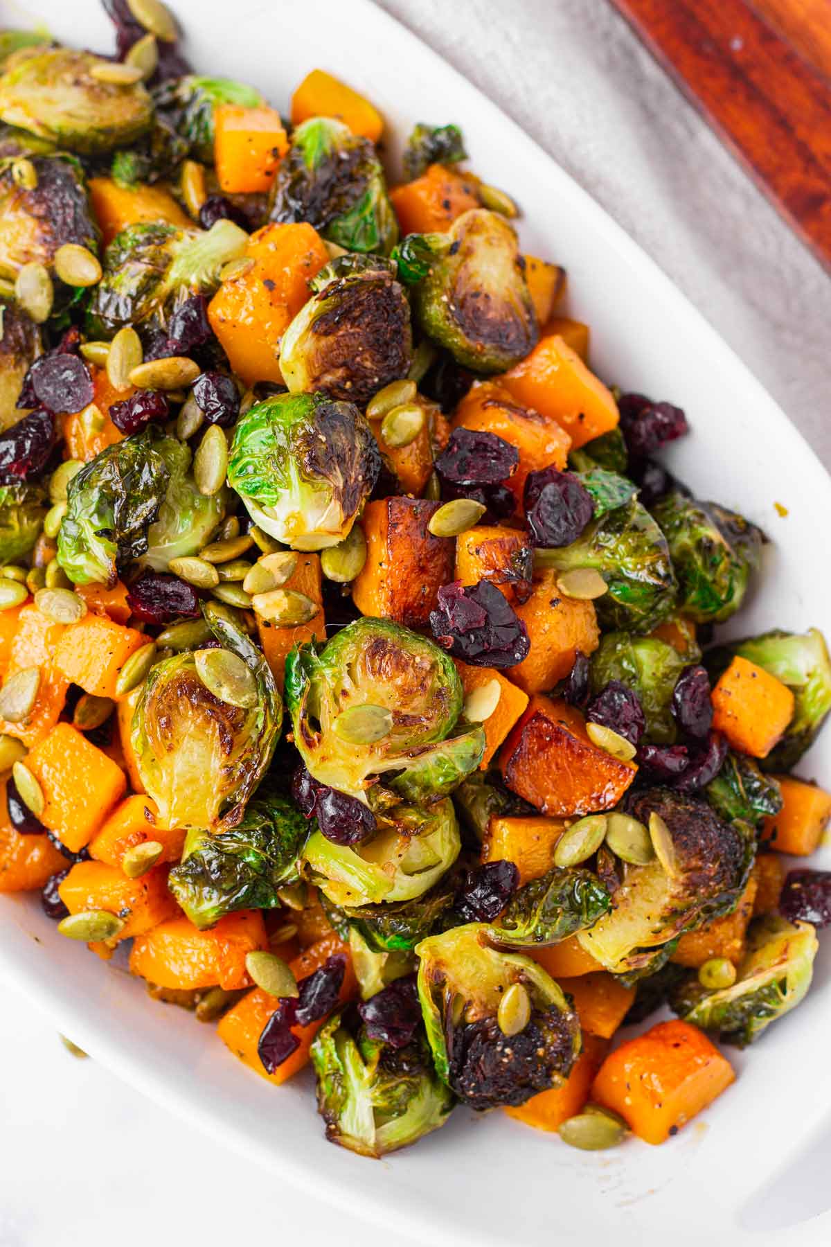 roasted butternut squash and brussels sprouts in oval dish