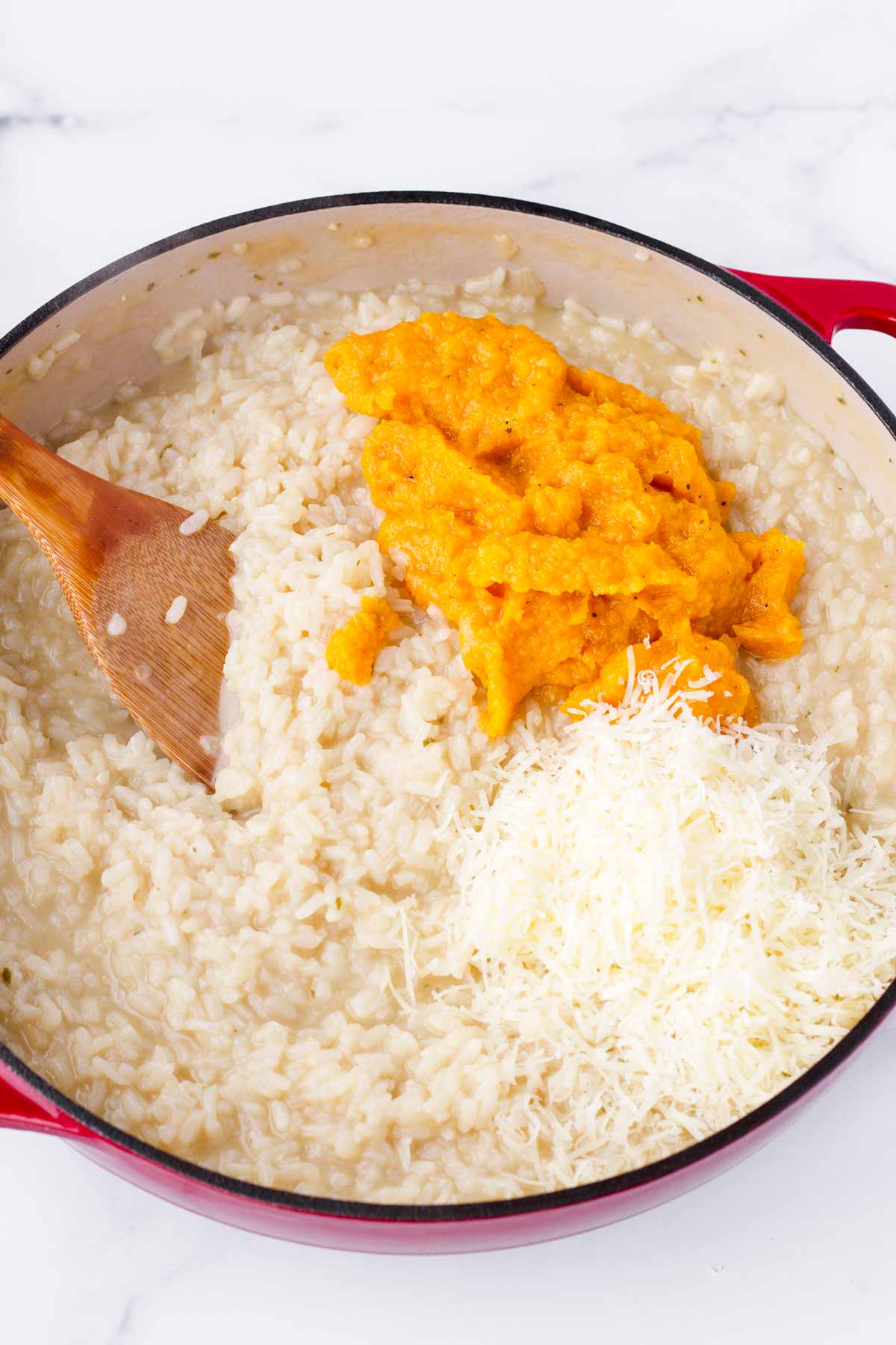 mixing cheese and butternut squash puree into rice