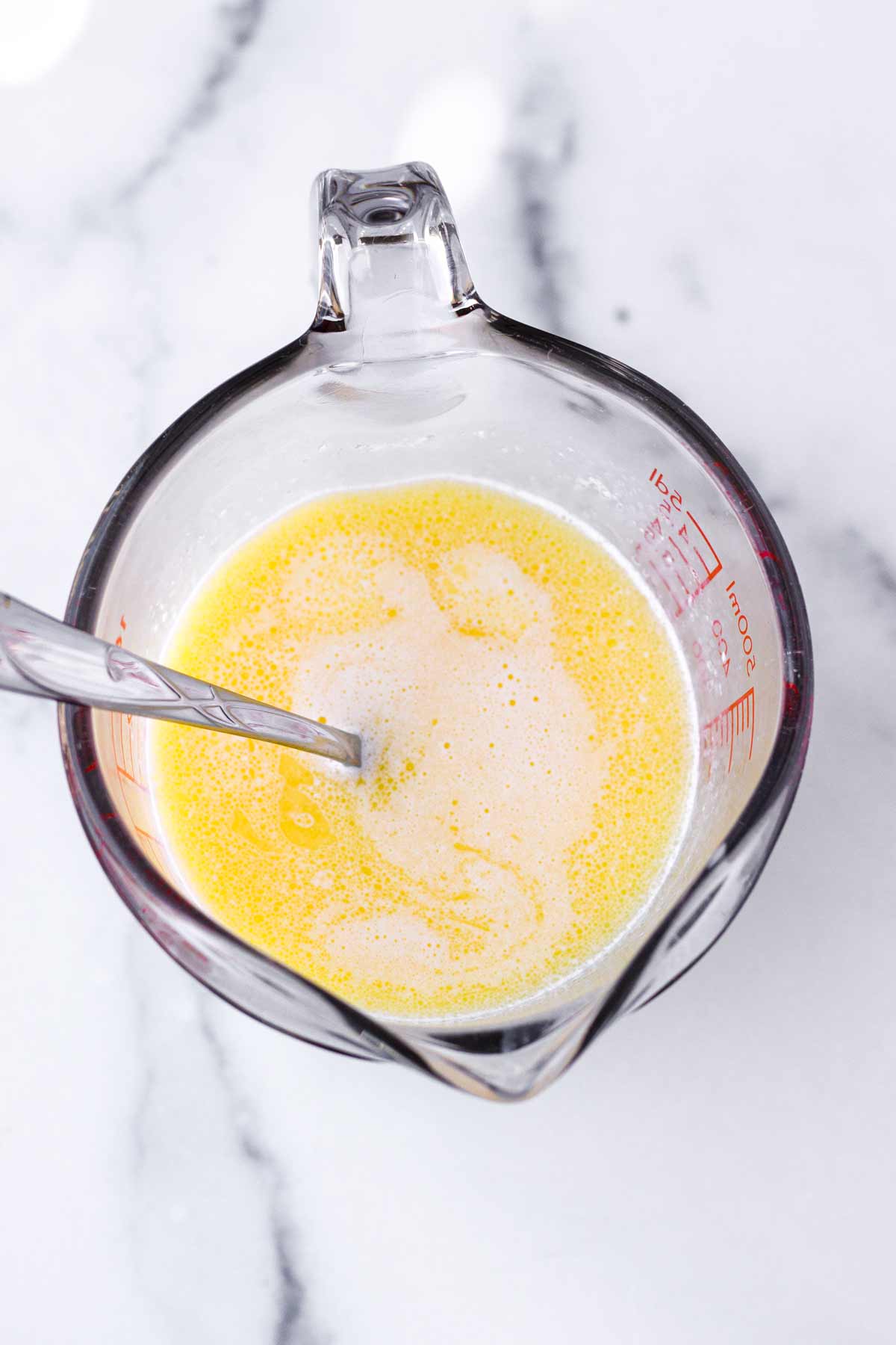 melted butter and cream in a glass measuring cup