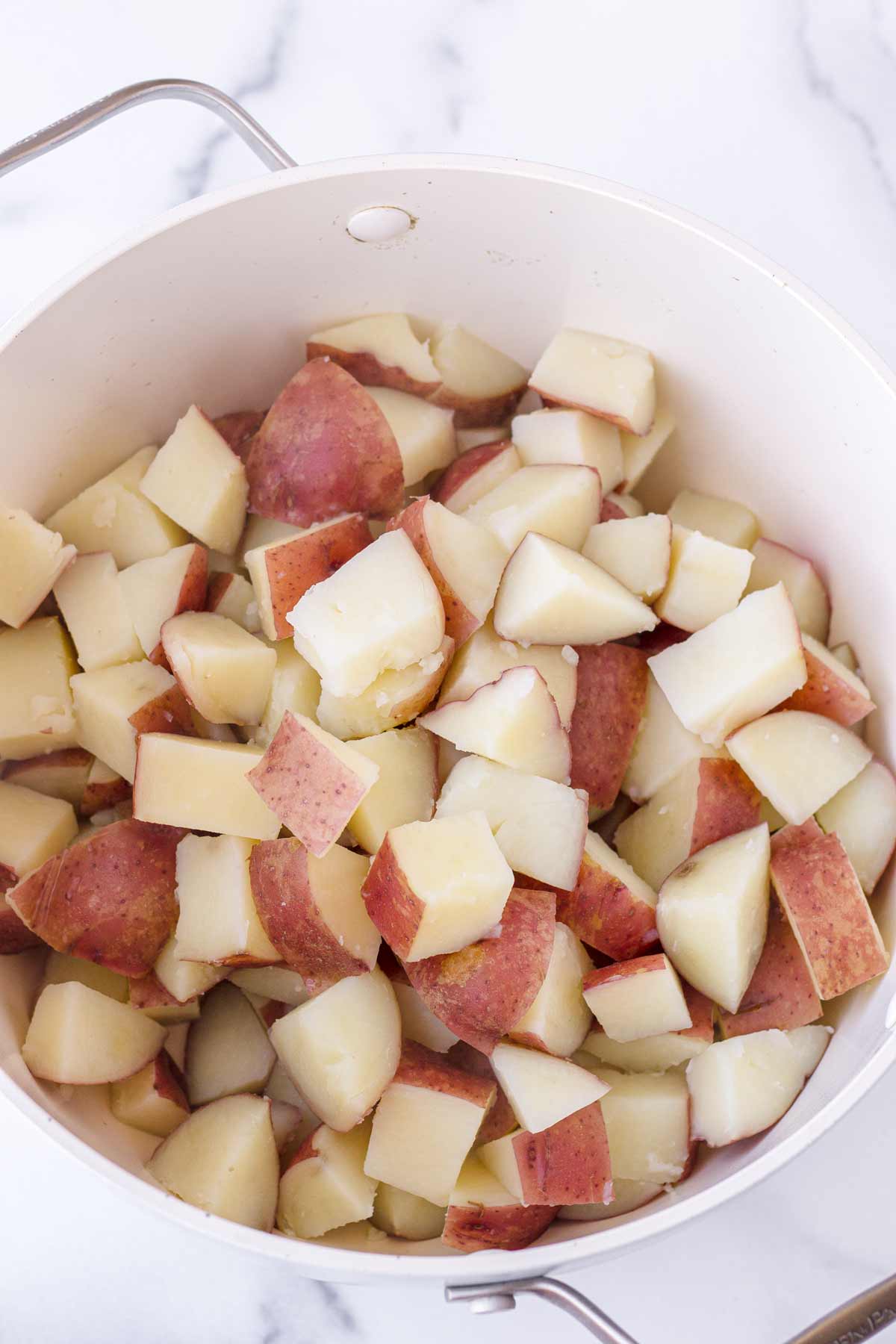 cooked diced red potatoes in a pot