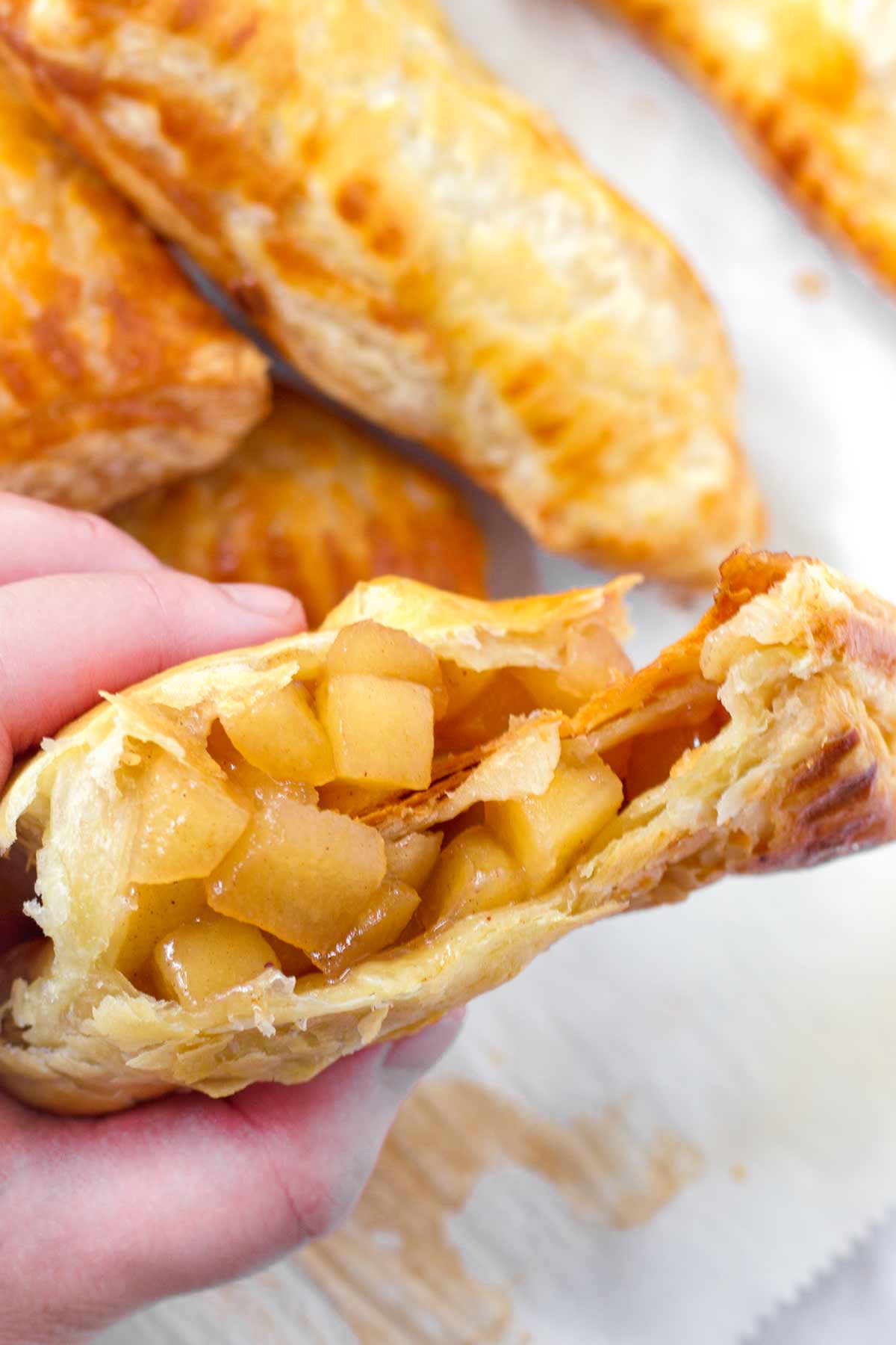 puff pastry apple turnover split in half showing the filling