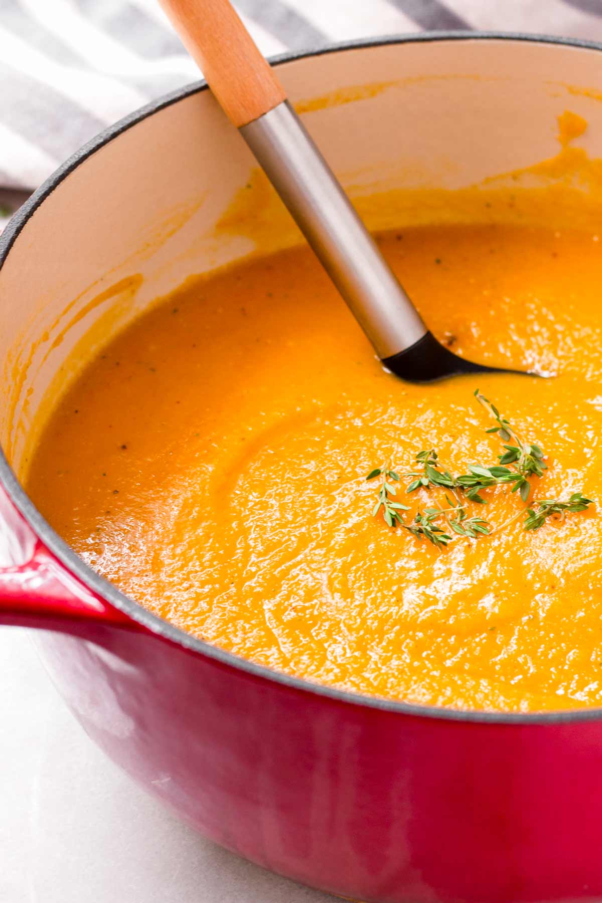 garnished roasted butternut squash soup in a pot