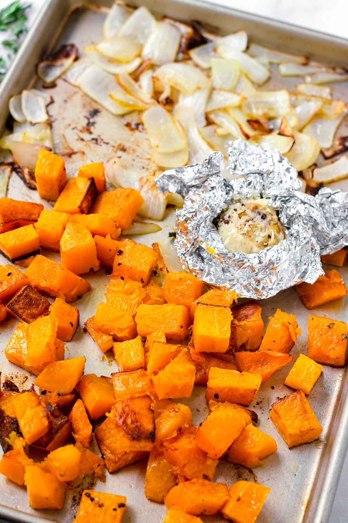 roasted squash, onions, and garlic in a sheet pan