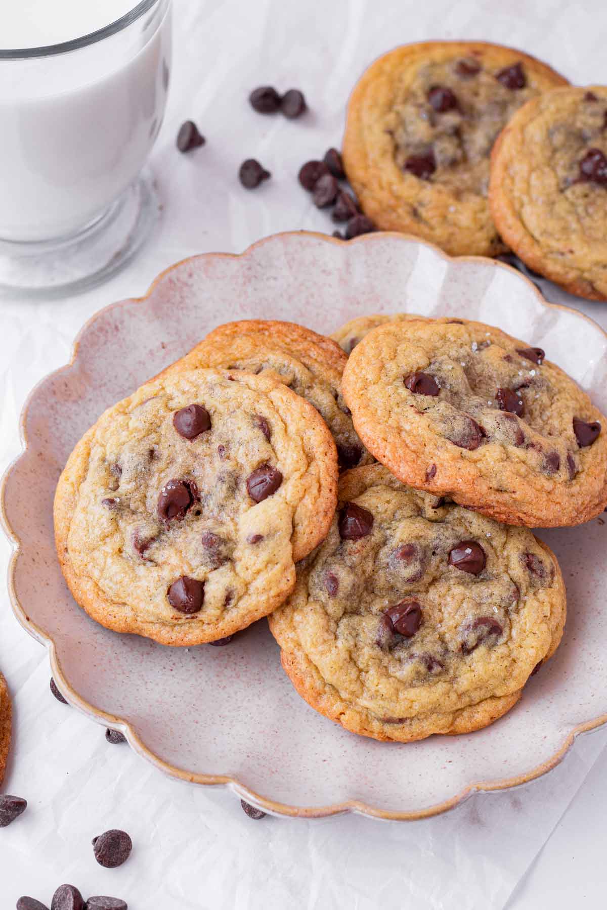 sea salt chocolate chip cookies on a plate with glass of milk