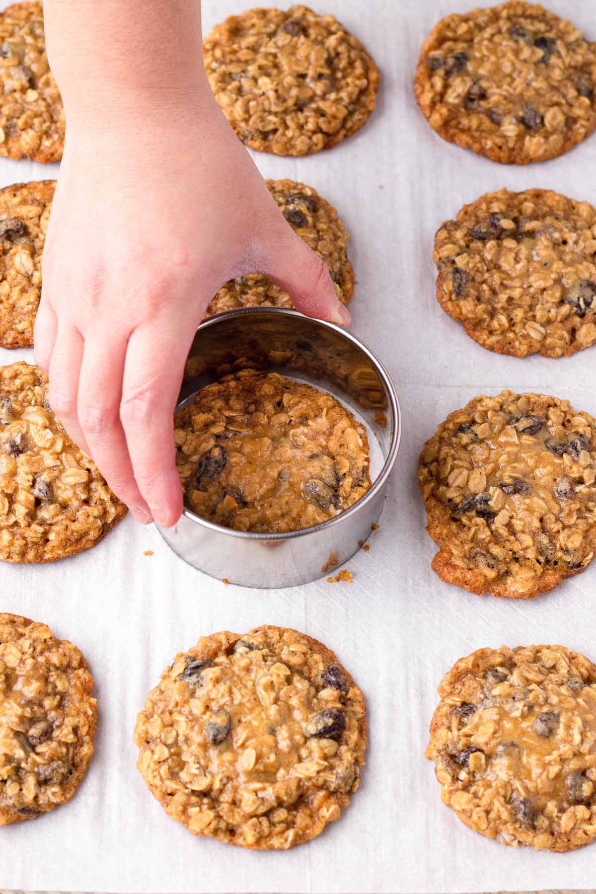 reshaping oatmeal raisin cookies with a cookie cutter